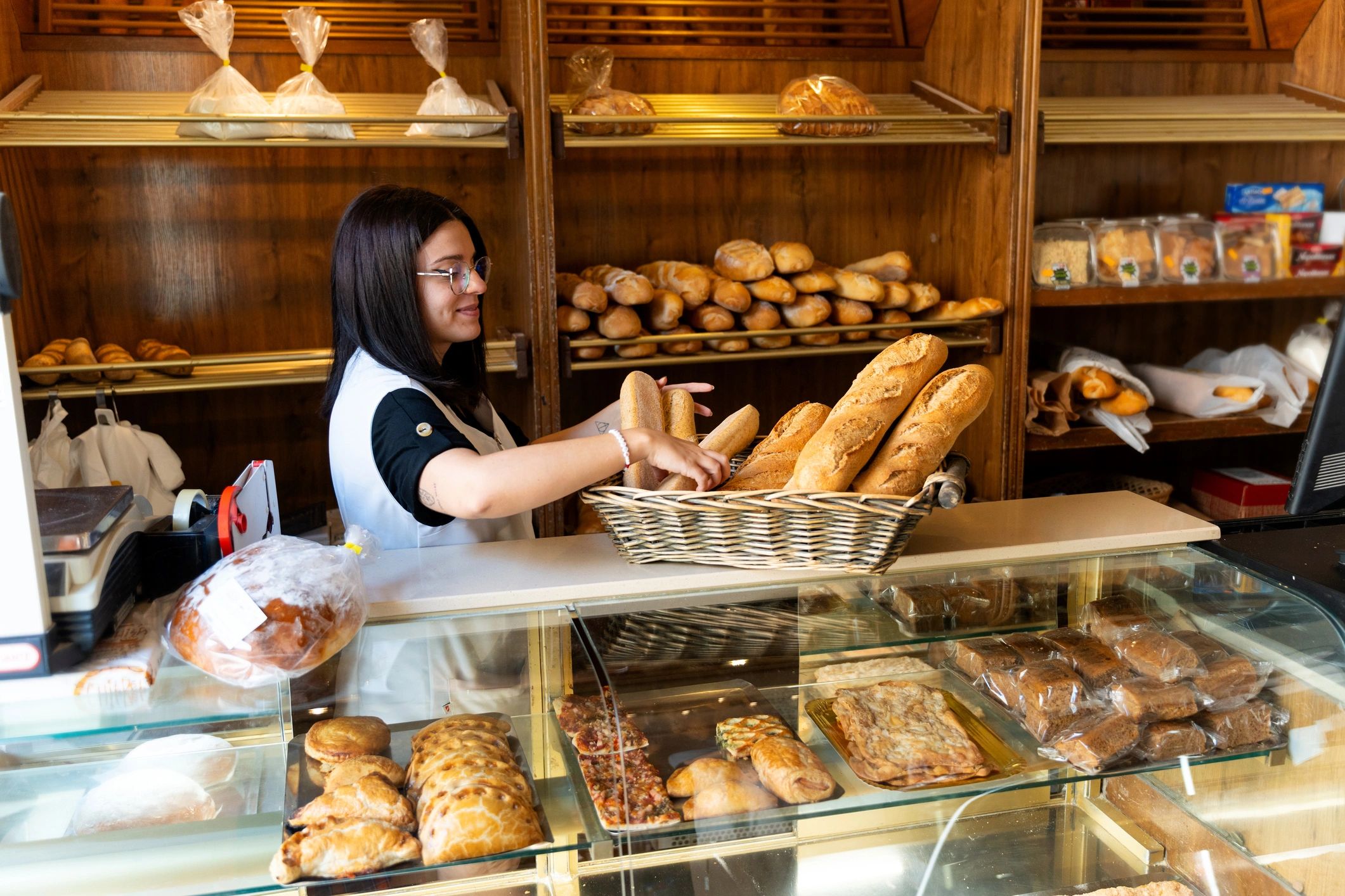 Lazio Bakery staff member smiling with fresh bread